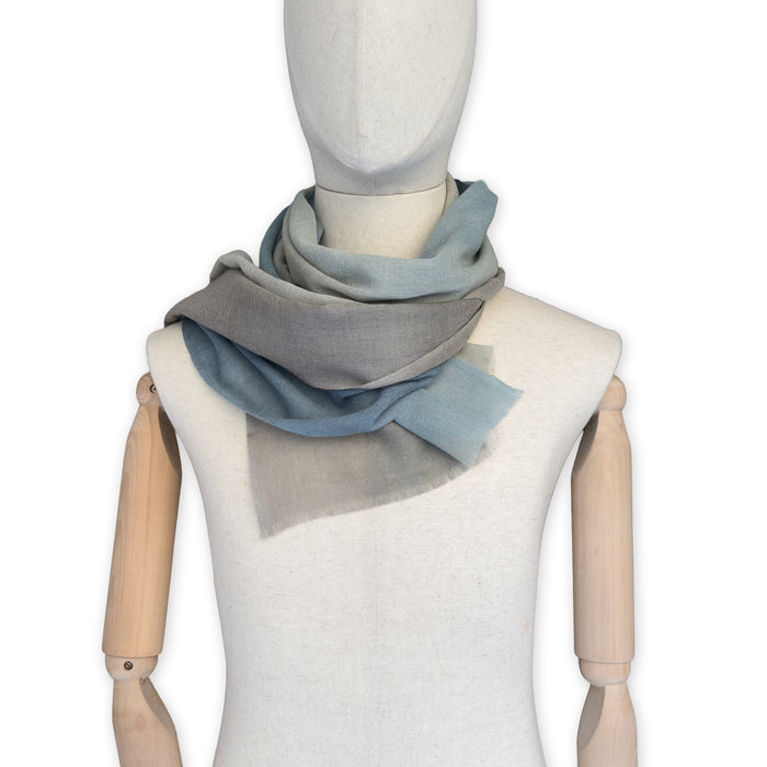Mannequin wearing scarf on a white background. Hand-painted wool scarf by Otta-Italy, 56 x 177 cm, featuring brown, beige and blue colors. Luxury Italian accessory, soft and warm scarf for women and men.
