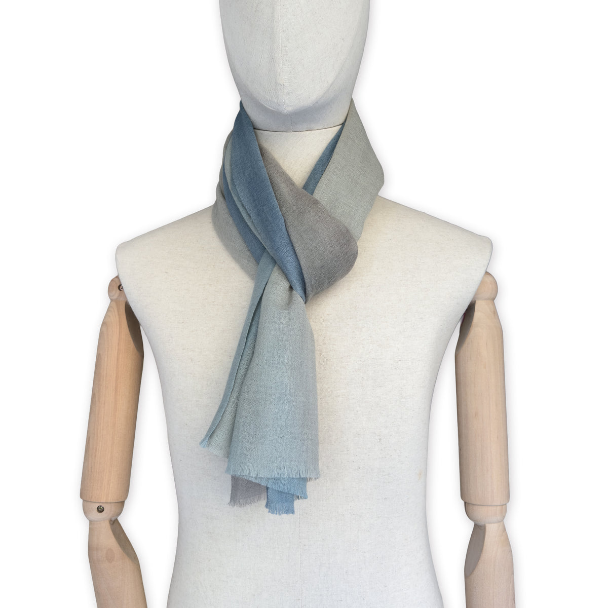 Mannequin wearing scarf on a white background. Hand-painted wool scarf by Otta-Italy, 56 x 177 cm, featuring brown, beige and blue colors. Luxury Italian accessory, soft and warm scarf for women and men.
