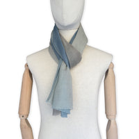 Mannequin wearing scarf on a white background. Hand-painted wool scarf by Otta-Italy, 56 x 177 cm, featuring brown, beige and blue colors. Luxury Italian accessory, soft and warm scarf for women and men.
