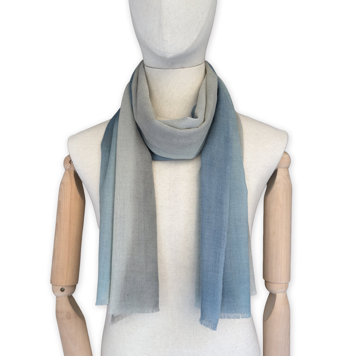Mannequin wearing scarf on a white background. Hand-painted wool scarf by Otta-Italy, 56 x 177 cm, featuring brown, beige and blue colors. Luxury Italian accessory, soft and warm scarf for women and men.
