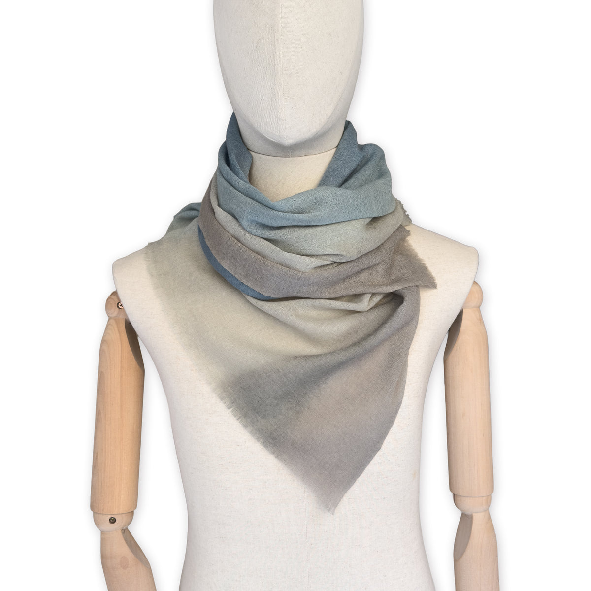 Mannequin wearing scarf on a white background. Hand-painted wool scarf by Otta-Italy, 56 x 177 cm, featuring brown, beige and blue colors. Luxury Italian accessory, soft and warm scarf for women and men.
