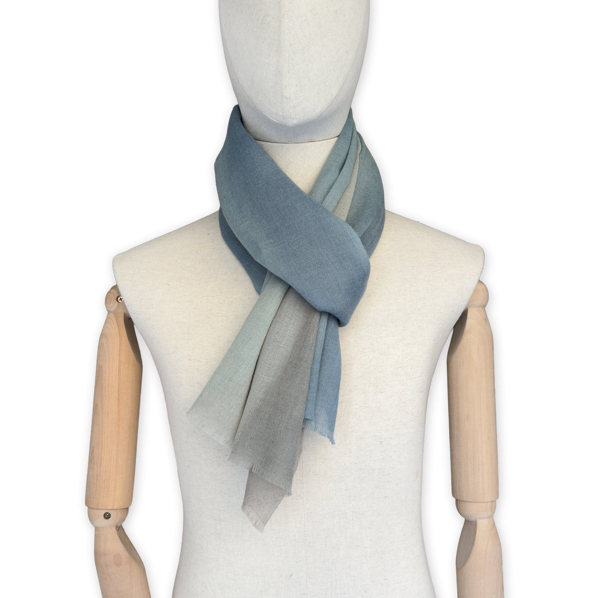 Mannequin wearing scarf on a white background. Hand-painted wool scarf by Otta-Italy, 56 x 177 cm, featuring brown, beige and blue colors. Luxury Italian accessory, soft and warm scarf for women and men.

