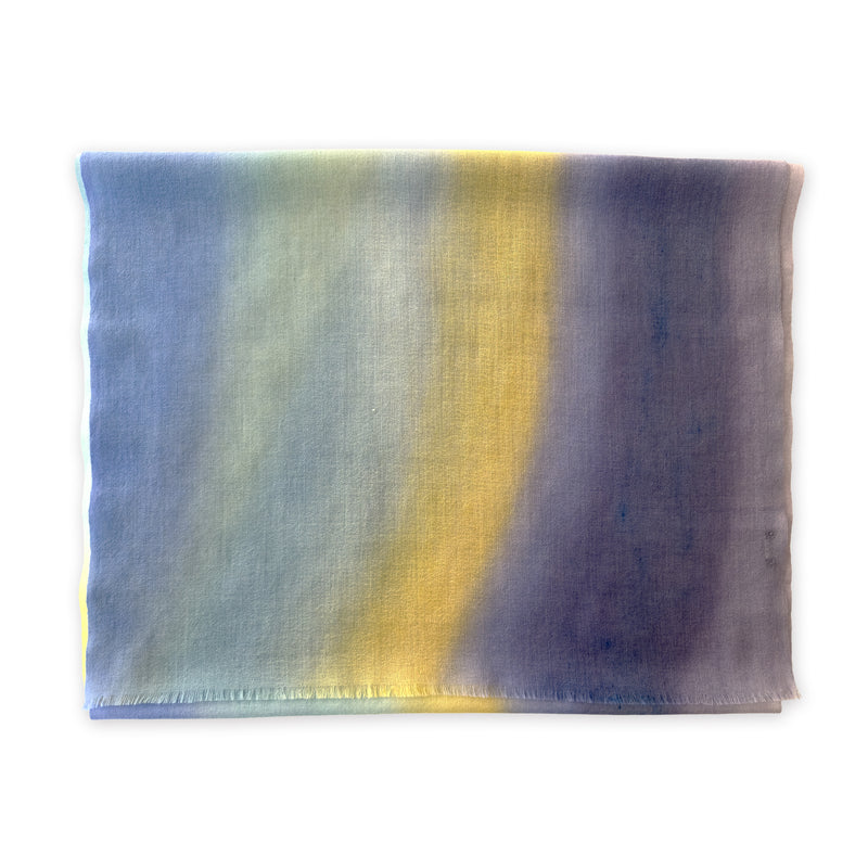 Colorful wool scarf in blue, purple, yellow shades on a white background. It is hand-painted scarf in measures 57 x 180 cm by otta-italy scarves brand. Luxury Italian accessory, soft and warm scarf for women and men.
