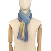 Mannequin wearing scarf on a white background. Hand-painted wool scarf by Otta-Italy, 57 x 180 cm, featuring blue, purple, yellow colors. Luxury Italian accessory, soft and warm scarf for women and men.
