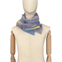 Mannequin wearing scarf on a white background. Hand-painted wool scarf by Otta-Italy, 57 x 180 cm, featuring blue, purple, yellow colors. Luxury Italian accessory, soft and warm scarf for women and men.
