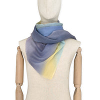 Mannequin wearing scarf on a white background. Hand-painted wool scarf by Otta-Italy, 57 x 180 cm, featuring blue, purple, yellow colors. Luxury Italian accessory, soft and warm scarf for women and men.
