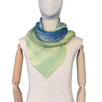Mannequin wearing scarf on a white background. Hand-painted mix wool and silk scarf by Otta-Italy, 193 x 54 cm, featuring blue, light green and yellow colors. Luxury Italian accessory, soft and warm scarf for women and men.
