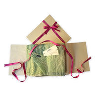 Set of scarves in a gift box with a pink ribbon on a white background. 
Hand-painted mix wool and silk scarf by Otta-Italy, 193 x 54 cm, featuring blue, light green and yellow colors. Luxury Italian accessory, soft and warm scarf for women and men.
