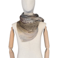 Mannequin wearing scarf on a white background. Hand-painted mix wool and silk scarf by Otta-Italy, 193 x 54 cm, featuring brown, gray and beige colors. Luxury Italian accessory, soft and warm scarf for women and men.
