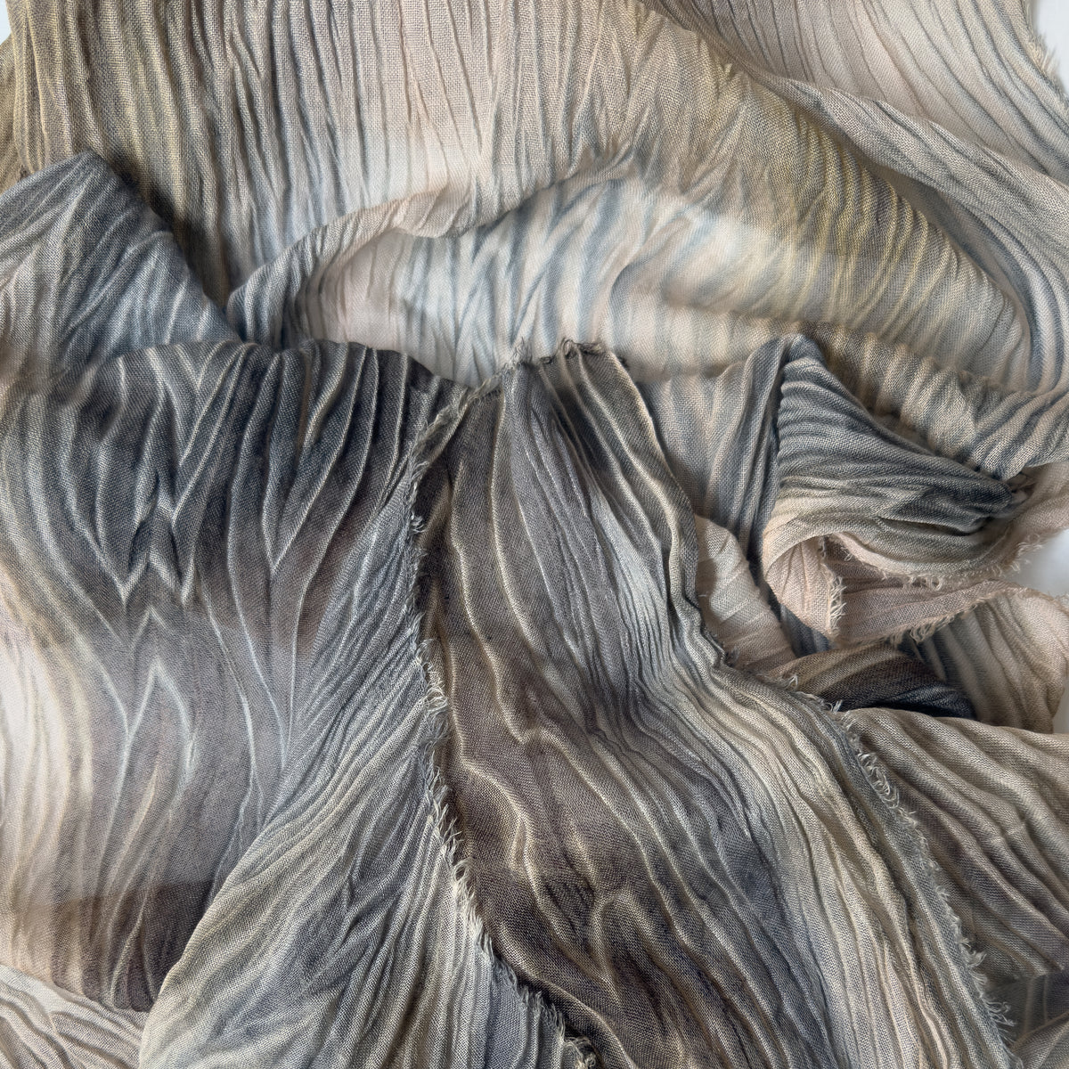 Close-up of soft fabric. Hand-painted mix wool and silk scarf by Otta-Italy, 193 x 54 cm, featuring brown, gray and beige colors. Luxury Italian mix accessory, soft and warm scarf for women and men.
