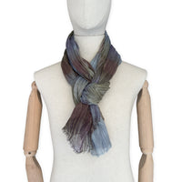 Mannequin wearing scarf on a white background. Hand-painted mix wool and silk scarf by Otta-Italy, 193 x 54 cm, featuring light blue, purple, brown and green colors. Luxury Italian accessory, soft and warm scarf for women and men.
