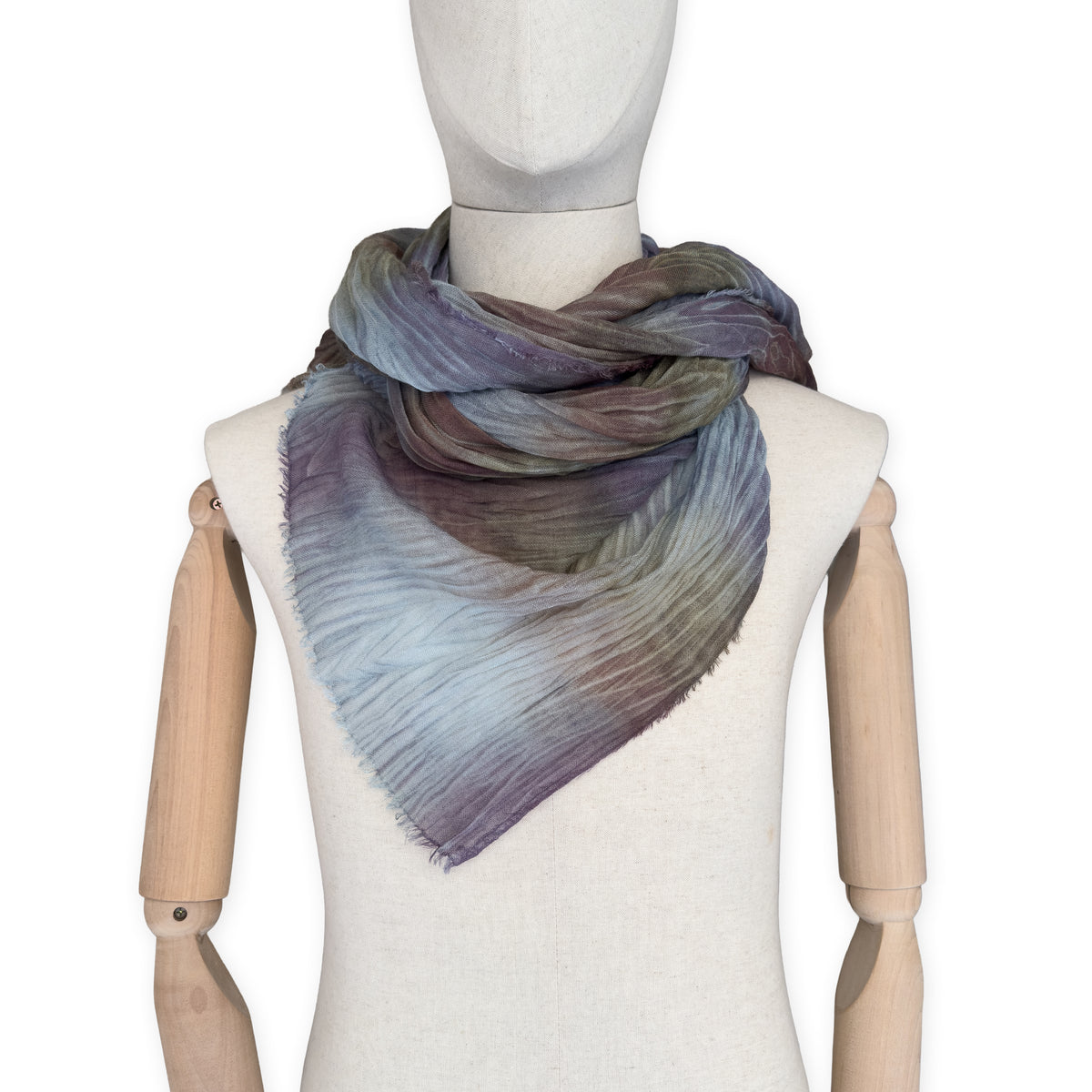 Mannequin wearing scarf on a white background. Hand-painted mix wool and silk scarf by Otta-Italy, 193 x 54 cm, featuring light blue, purple, brown and green colors. Luxury Italian accessory, soft and warm scarf for women and men.
