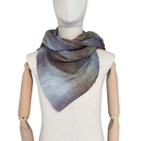 Mannequin wearing scarf on a white background. Hand-painted mix wool and silk scarf by Otta-Italy, 193 x 54 cm, featuring light blue, purple, brown and green colors. Luxury Italian accessory, soft and warm scarf for women and men.
