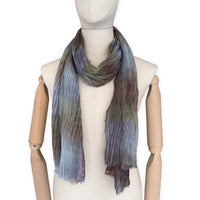 Mannequin wearing scarf on a white background. Hand-painted mix wool and silk scarf by Otta-Italy, 193 x 54 cm, featuring light blue, purple, brown and green colors. Luxury Italian accessory, soft and warm scarf for women and men.
