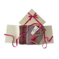 Set of scarves in a gift box with a pink ribbon on a white background. 
Hand-painted mix wool and silk scarf by Otta-Italy, 67 x 198 cm, featuring brown, gray and red colors. Luxury Italian accessory, soft and warm scarf for women and men.

