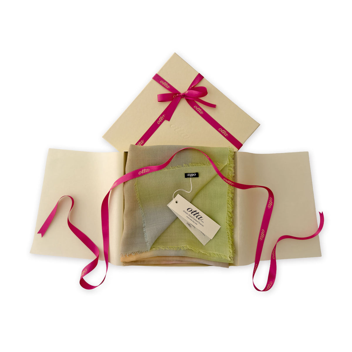 Luxury gift box with a pink ribbon containing a hand-painted Otta wool silk blend scarf on a white background.
