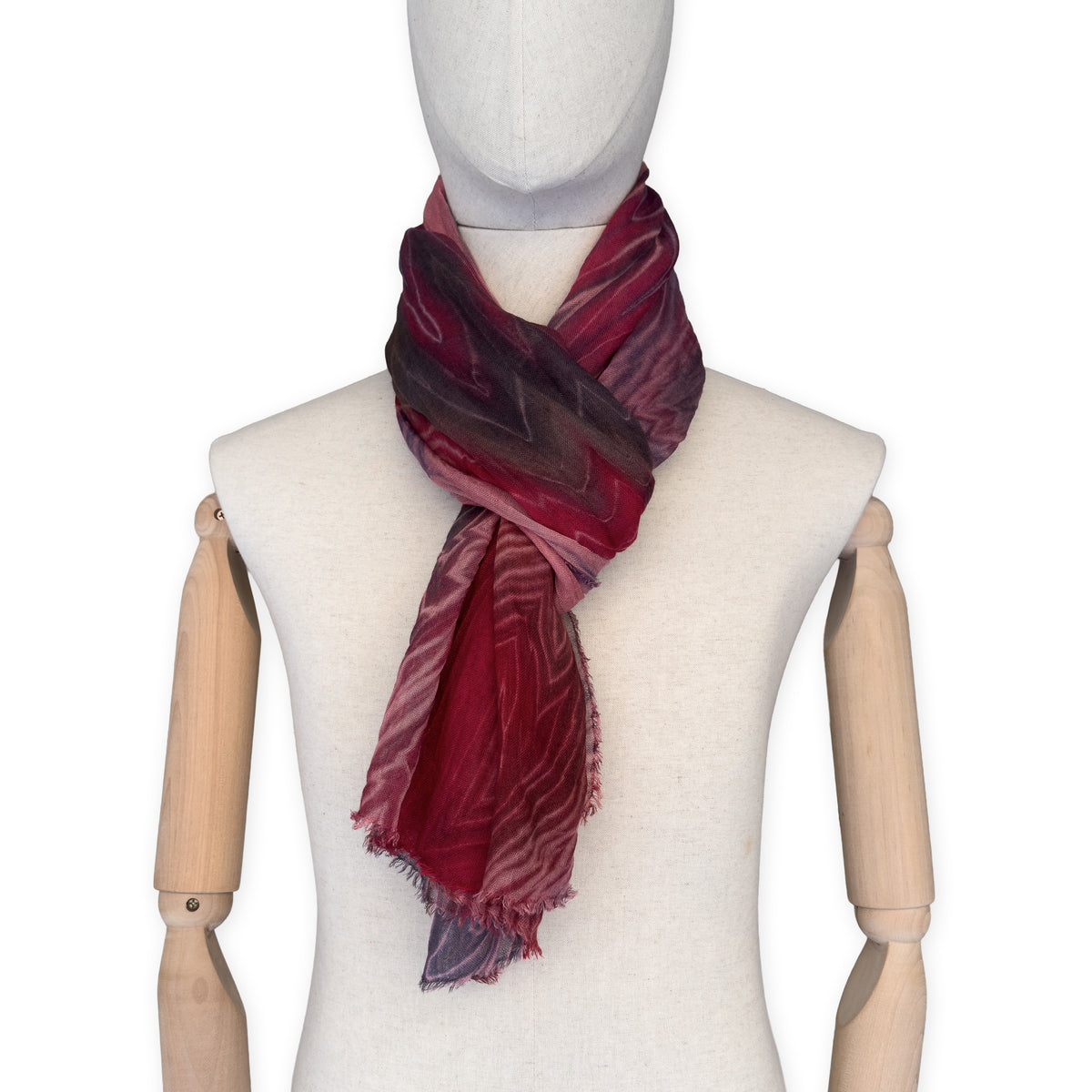 Mannequin wearing scarf on a white background. Hand-painted mix wool and silk scarf by Otta-Italy, 193 x 54 cm, featuring red, purple and dark gray colors. Luxury Italian accessory, soft and warm scarf for women and men.
