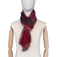 Mannequin wearing scarf on a white background. Hand-painted mix wool and silk scarf by Otta-Italy, 193 x 54 cm, featuring red, purple and dark gray colors. Luxury Italian accessory, soft and warm scarf for women and men.
