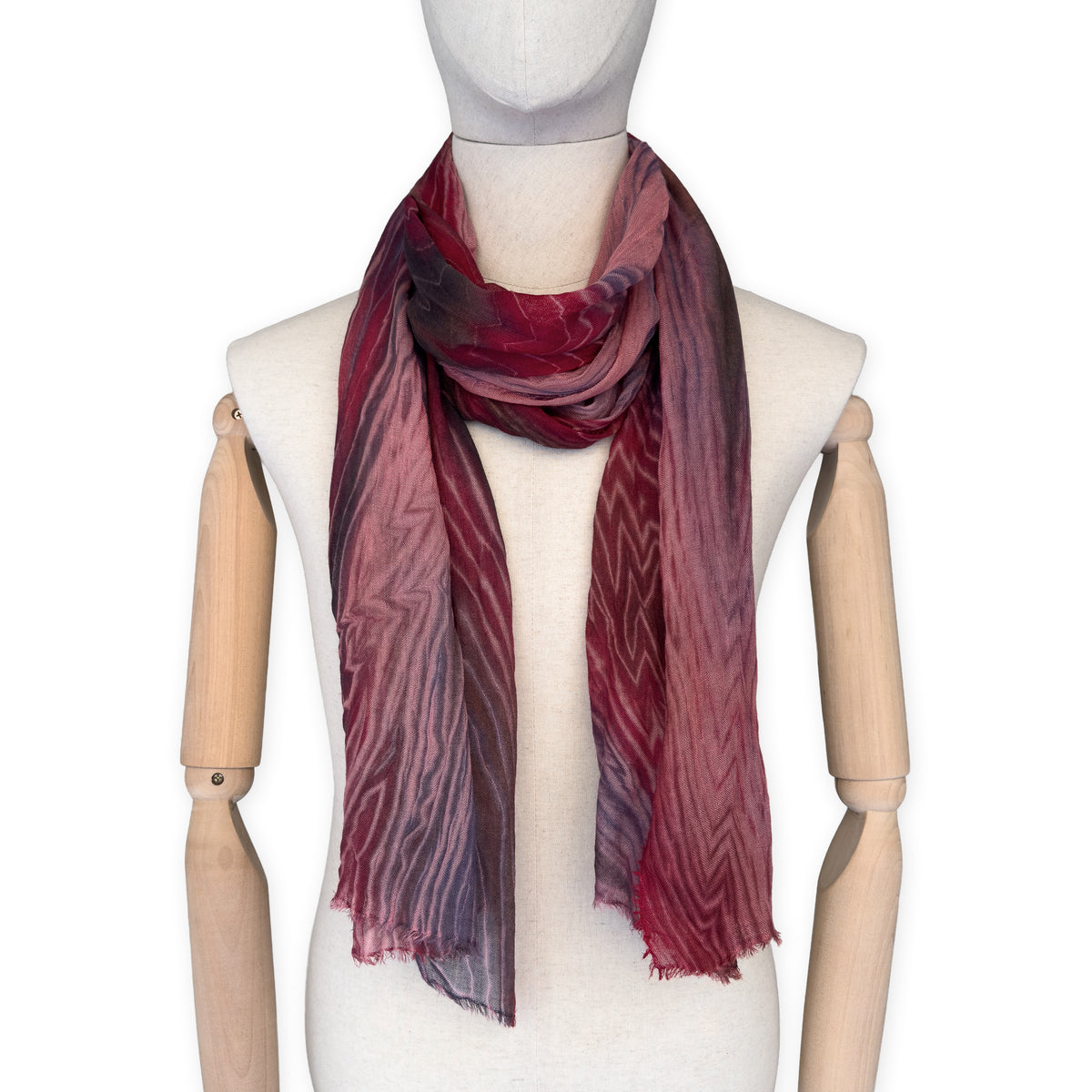 Mannequin wearing scarf on a white background. Hand-painted mix wool and silk scarf by Otta-Italy, 193 x 54 cm, featuring red, purple and dark gray colors. Luxury Italian accessory, soft and warm scarf for women and men.
