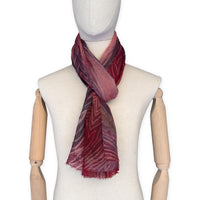 Mannequin wearing scarf on a white background. Hand-painted mix wool and silk scarf by Otta-Italy, 193 x 54 cm, featuring red, purple and dark gray colors. Luxury Italian accessory, soft and warm scarf for women and men.
